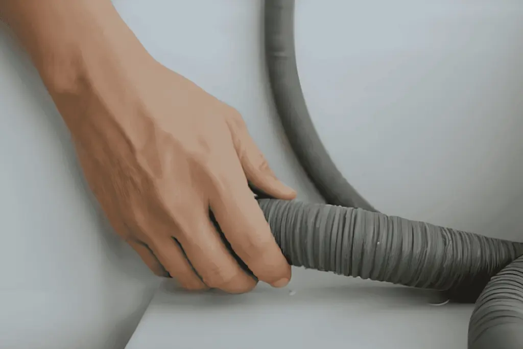 A dryer vent hose being cleaned